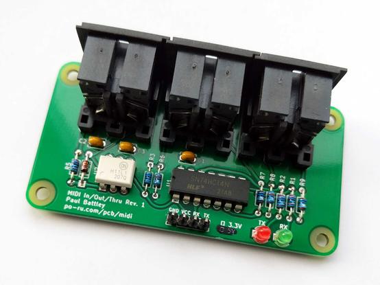 A circuit board with a few chips and passive components and three large DIN sockets.